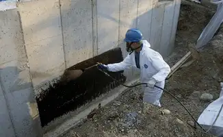 Professional waterproofing the exterior walls of the basement in Louisville, KY