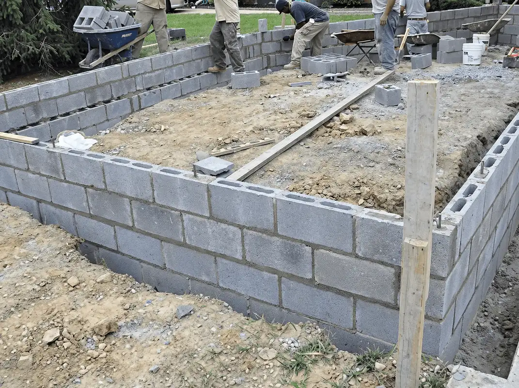 Professionals building a foundation with blocks in Louisville, KY
