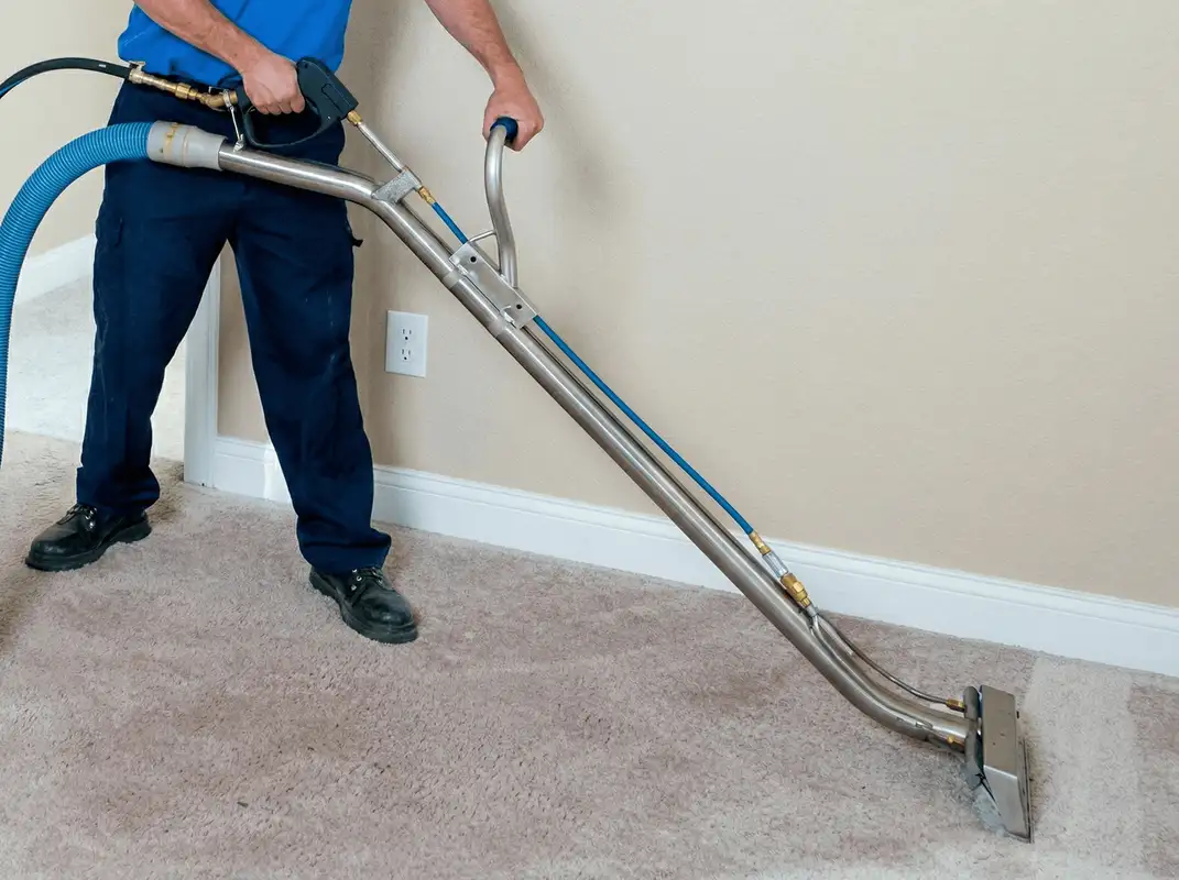 Professional operating a liquid removal machine on a carpeted floor in Louisville, KY